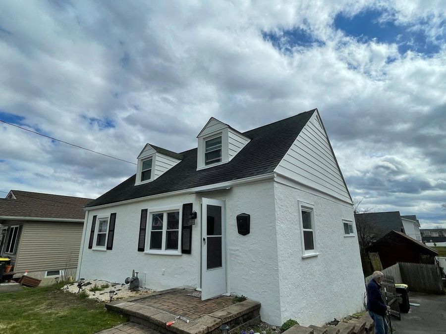Exterior house painting, finished white cape