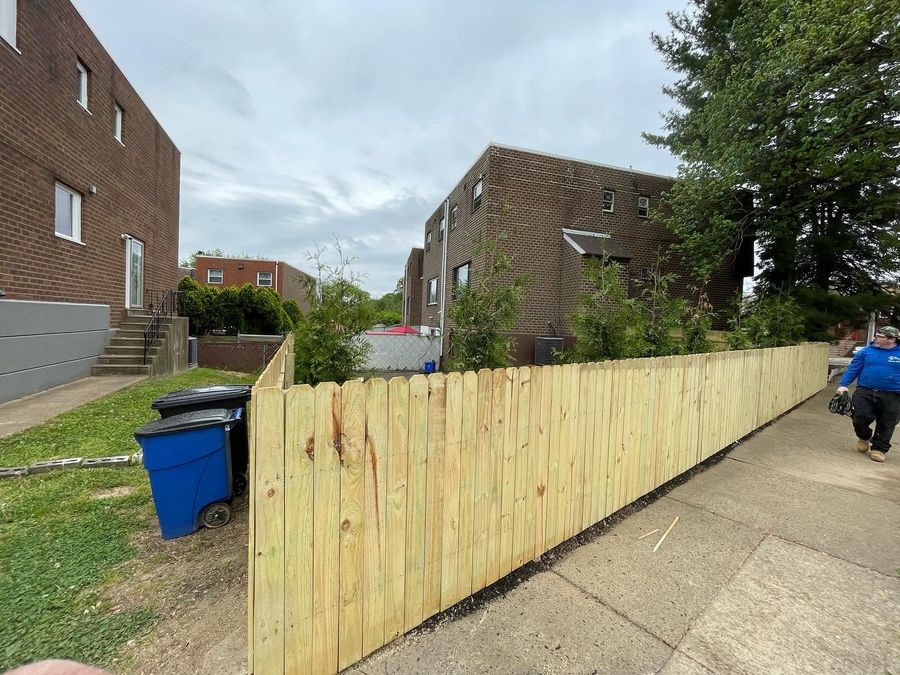 New wood privacy fence along sidewalk